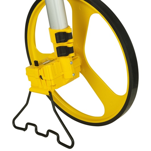 Photo of STANLEY 1-77-174 measuring wheel, close-up side view showing yellow wheel, handle, and black stand.