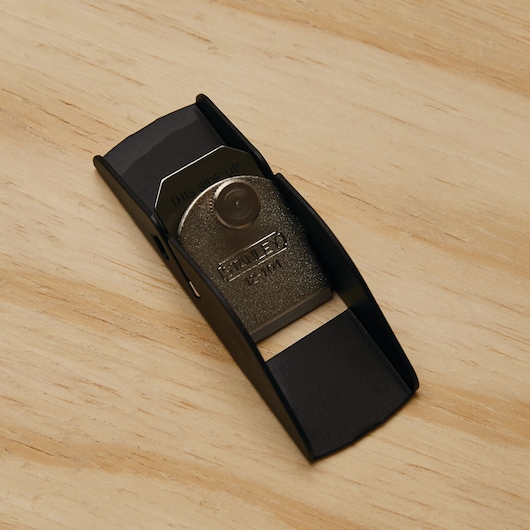 Photo of STANLEY 12-101 block plane with metal body and blade, shown on a wooden surface.