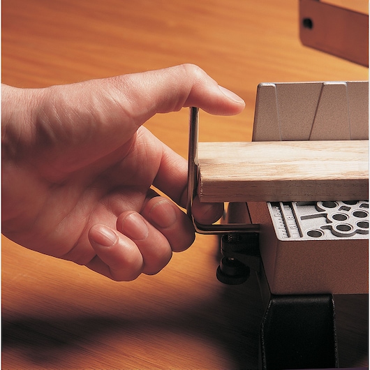 STANLEY 20-800 photography of a hand using a miter box to secure a wooden piece, close-up view.