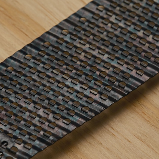 STANLEY 21-398 replacement surform blade with perforated holes, close-up angle on wood surface.