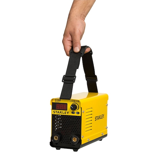 Photo of STANLEY 61316 portable yellow welding machine with display and strap, held by a hand, front angle.