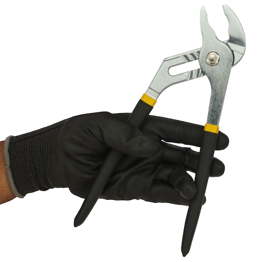 Photo of STANLEY 84-110-23 adjustable pliers held in a gloved hand, black and silver handles, side angle.