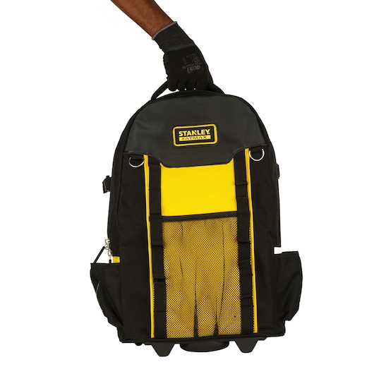 STANLEY FMST514196 black and yellow tool backpack, front angle, held by gloved hand