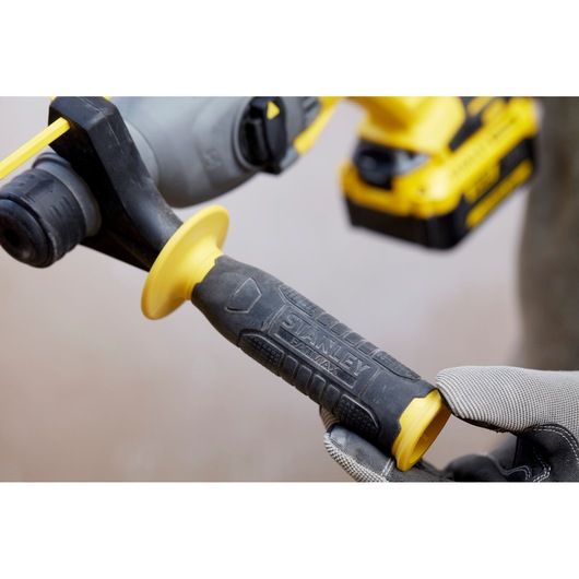 Photo of STANLEY SBH900 power tool handle with textured black and yellow grip, close-up view.