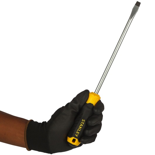 Photo of STANLEY STMT60832-8 flathead screwdriver with yellow and black handle held by gloved hand.