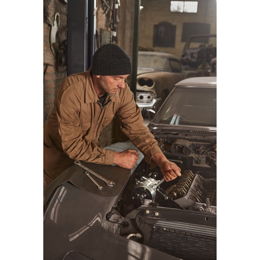 STANLEY STMT72811 photography of mechanic using wrenches on car engine in garage.