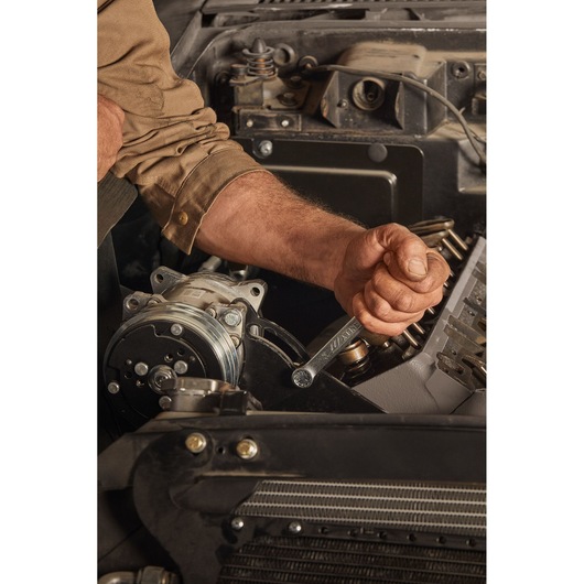 STANLEY STMT72811 hand tool, wrench used on car engine, close-up photography.