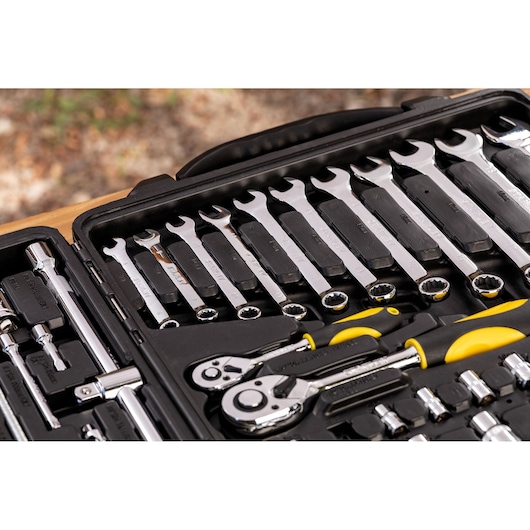 STANLEY STMT81243-LA mechanic tool set with wrenches, ratchets, and sockets organized in a black case, angled view.
