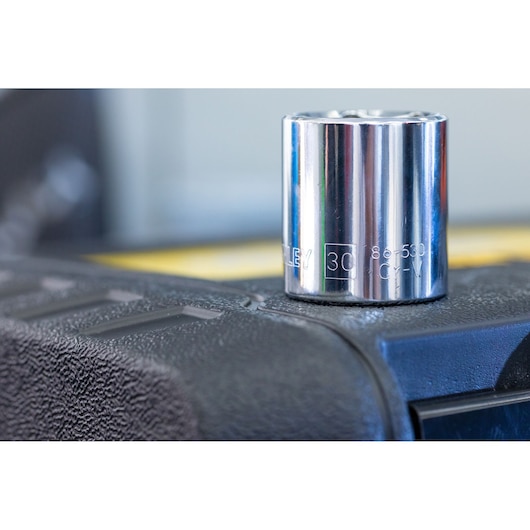 STANLEY STMT82828-LA chrome socket, close-up on textured black surface, photography product.