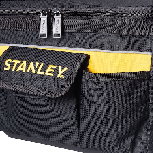 Photo of STANLEY STST1-73615 tool bag, close-up showing black fabric, yellow accents, front pockets, and zippers.